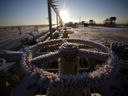 Ice sits on a valve actuating wheel connected to pipework at a natural gas field in Russia. 