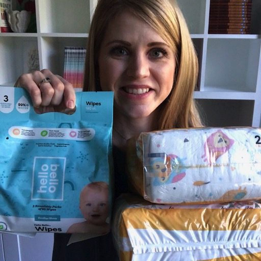 Mom holds up diapers and wipes