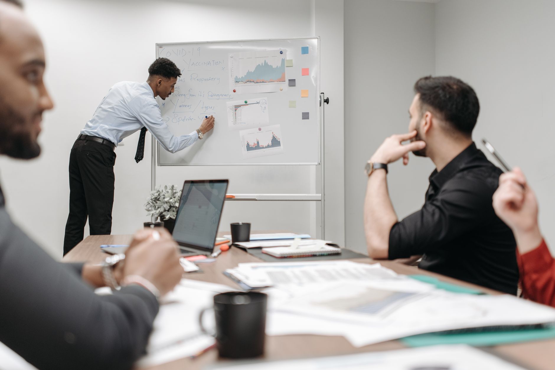 Colleagues in a business meeting discussing data and strategies at the office. — Award-Winning Detroit Photographer for Weddi