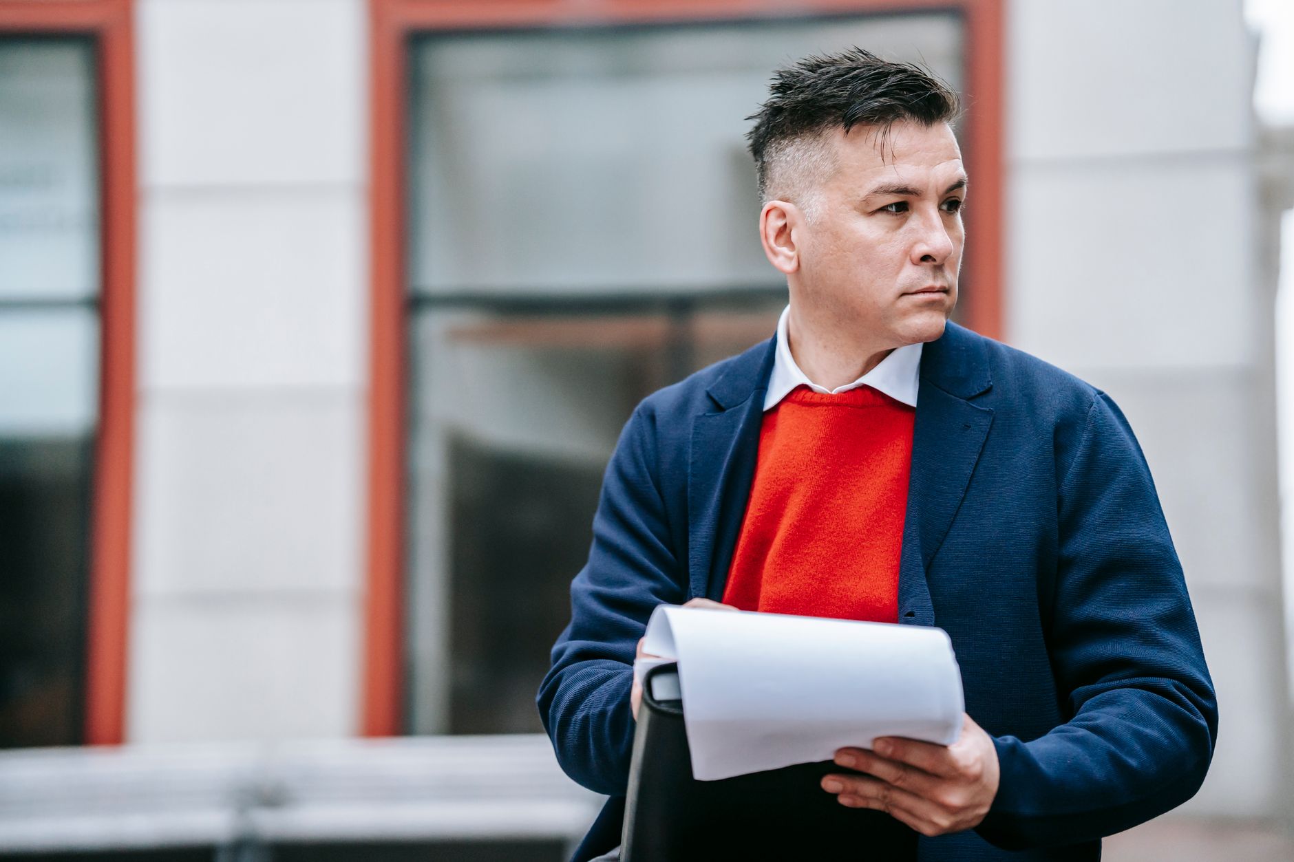 A serious man holding papers, dressed professionally in an urban environment. — Danish IPTV Viewing Experience with Smooth Pl