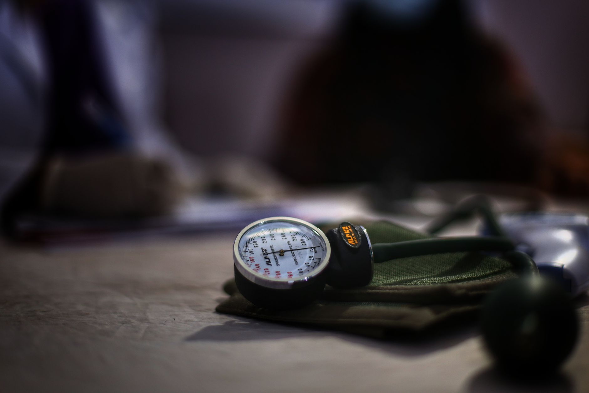Detailed image of a medical sphygmomanometer on a table, indicating health check-up setting. — From Convenience to Cost: The