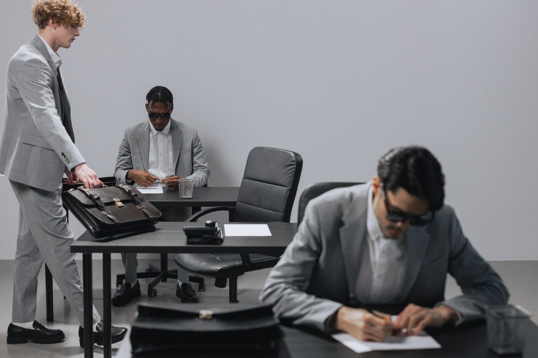 Business office with diverse employees in gray suits working at desks in an indoor setting. — How Adult Films Can Contribute