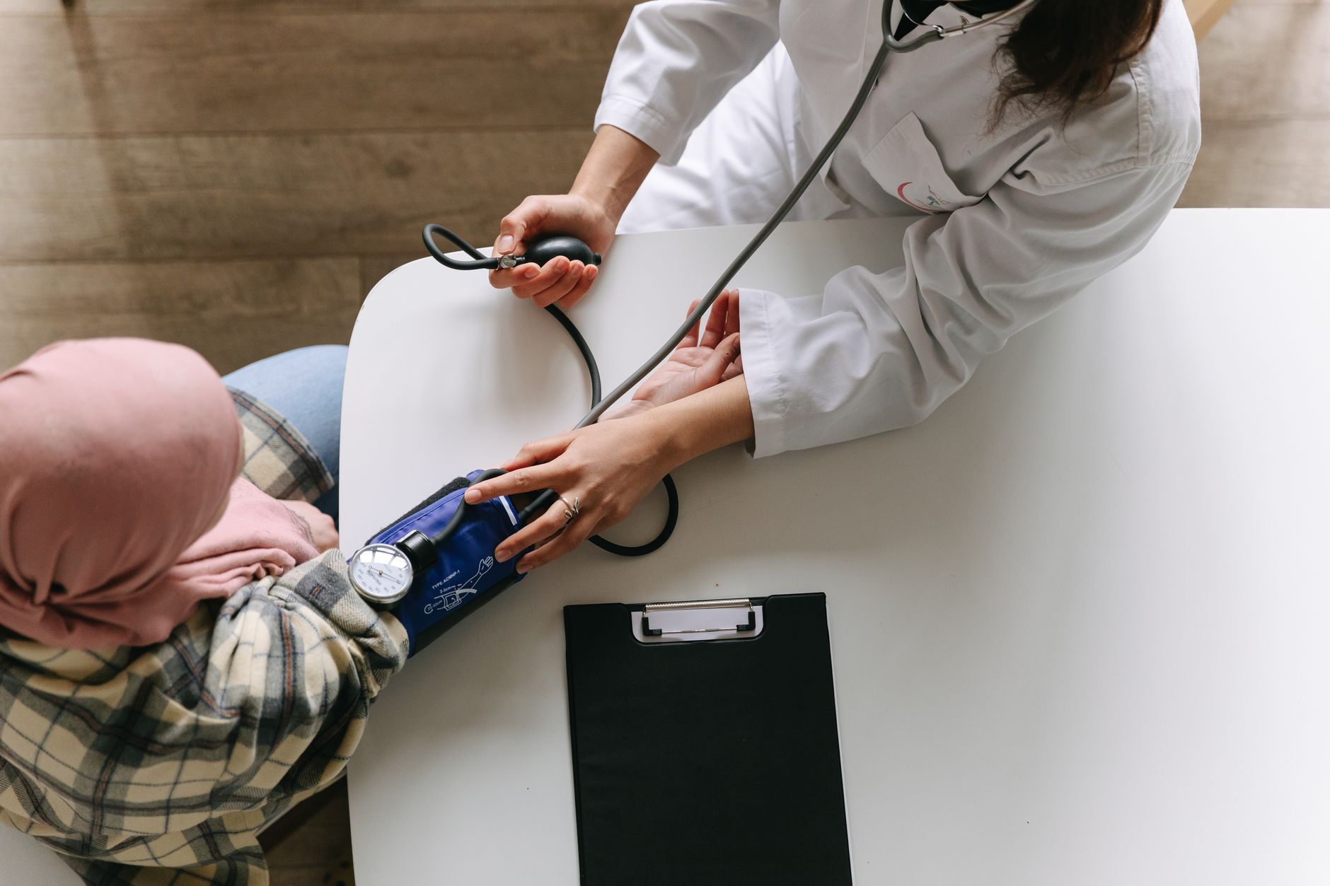 A medical practitioner checks a patient's blood pressure in a clinical setting, showcasing healthcare service. — How to Find