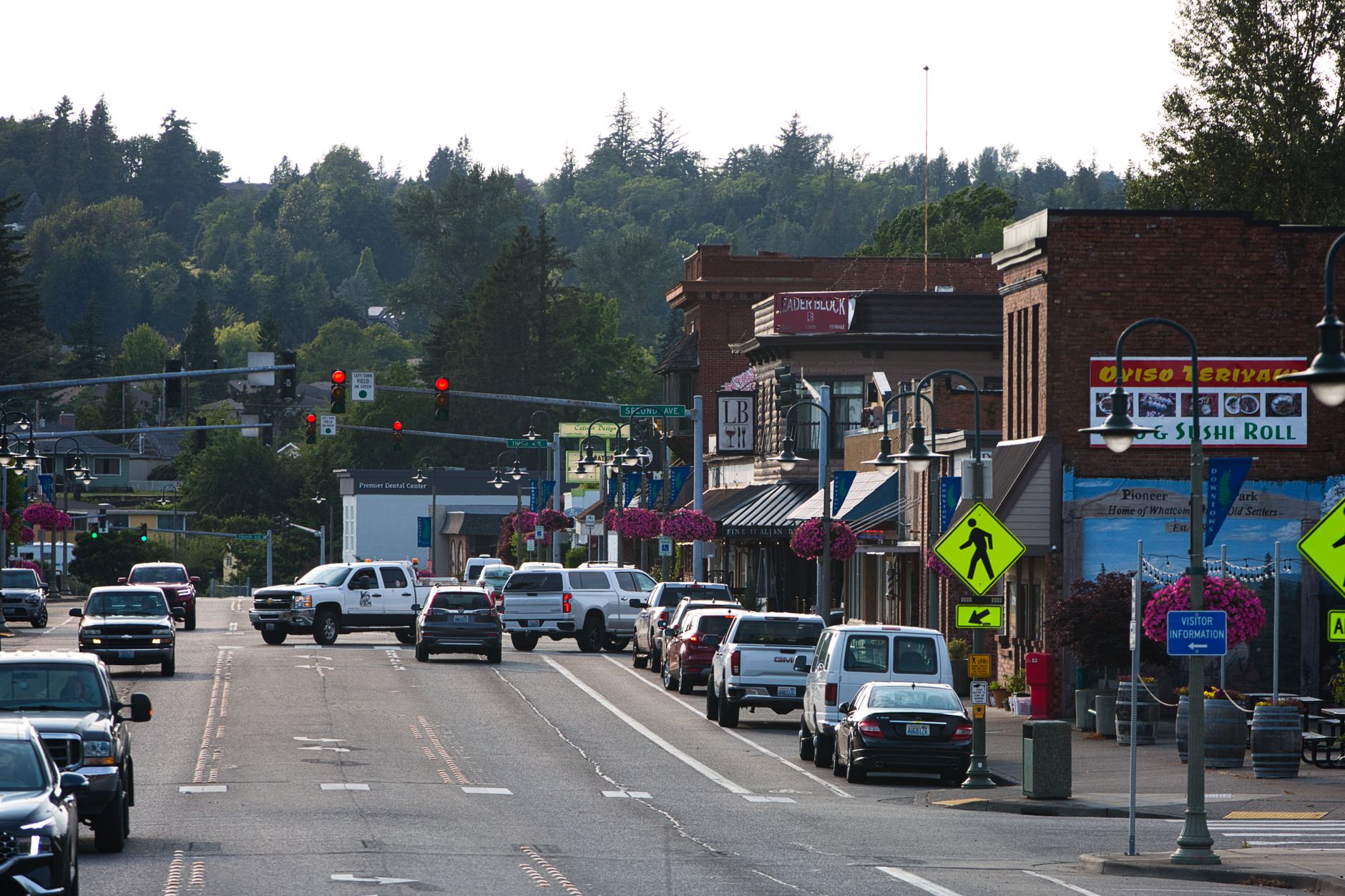 Lively urban street with cars, shops, and pedestrians during daytime. — Maximizing Retirement Savings: How Restricted Propert