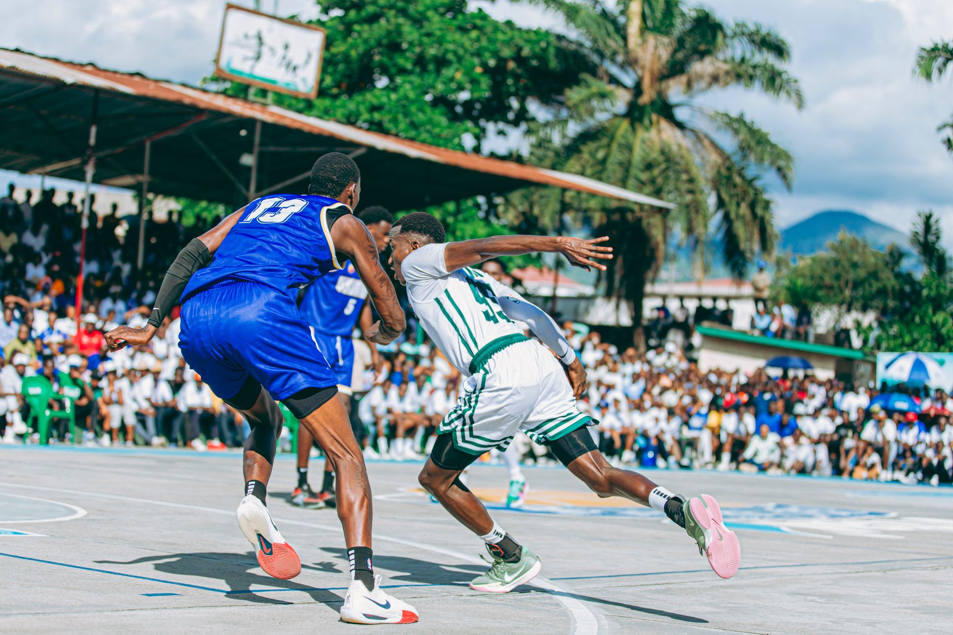 Players compete in an exciting outdoor basketball game with a lively crowd watching. — No Subscription Needed: Watch Free Spo