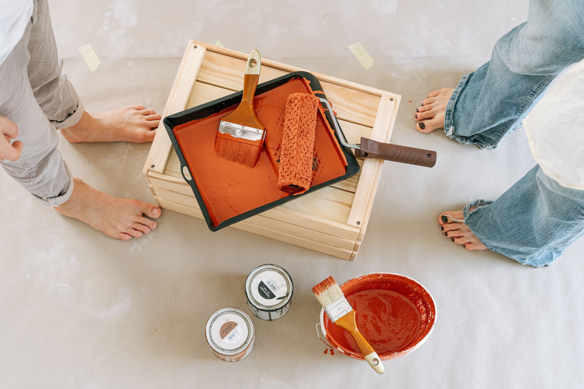 Overhead view of a renovation setup with paint, brushes, and bare feet. — "Professional Window Installation in Redmond: Preci