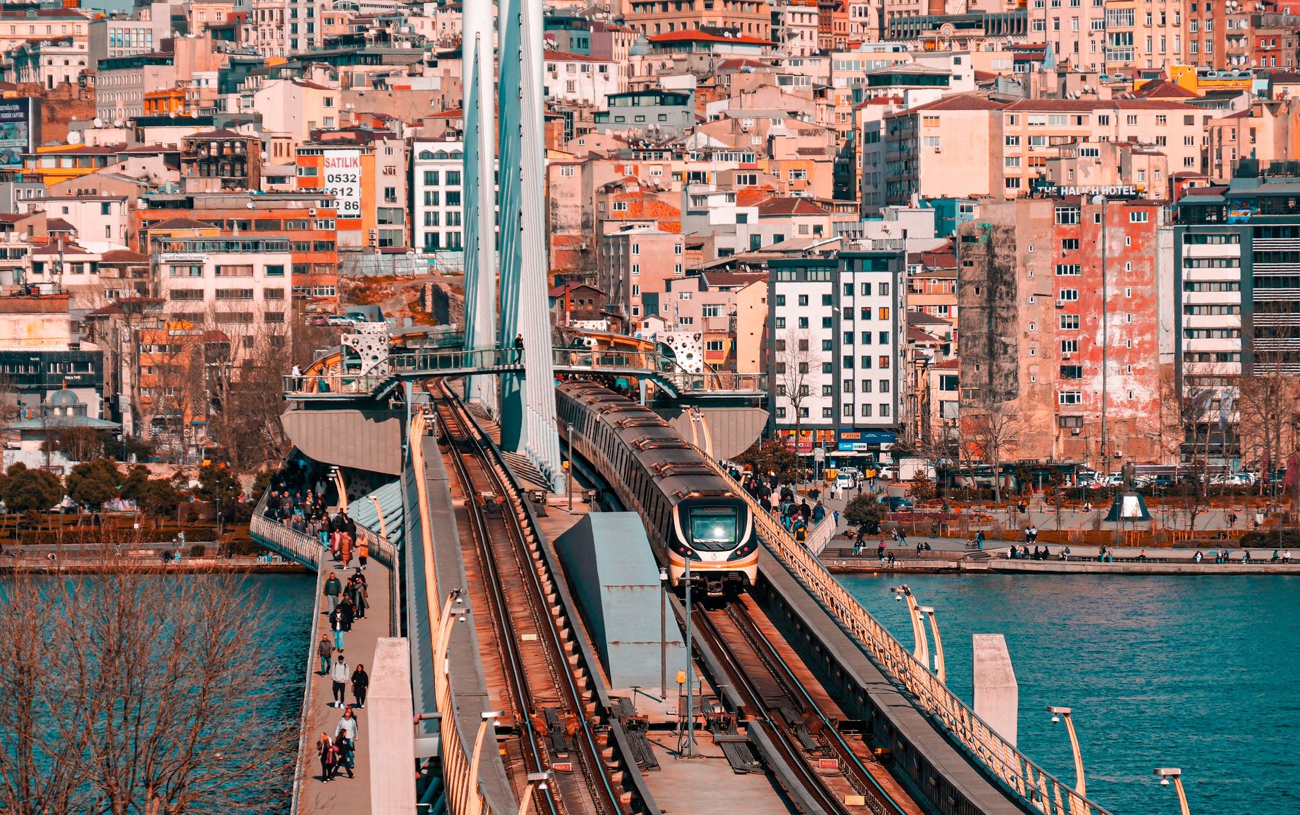 Metro train crossing a bridge in Istanbul with a vibrant cityscape backdrop. — sex photography - Discreet and Tasteful Sessio