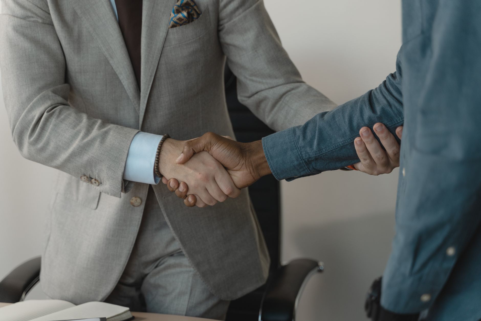 Image of a professional handshake between two businessmen in an office setting. — Sparkling Clean Homes: Our Commitment to Hy