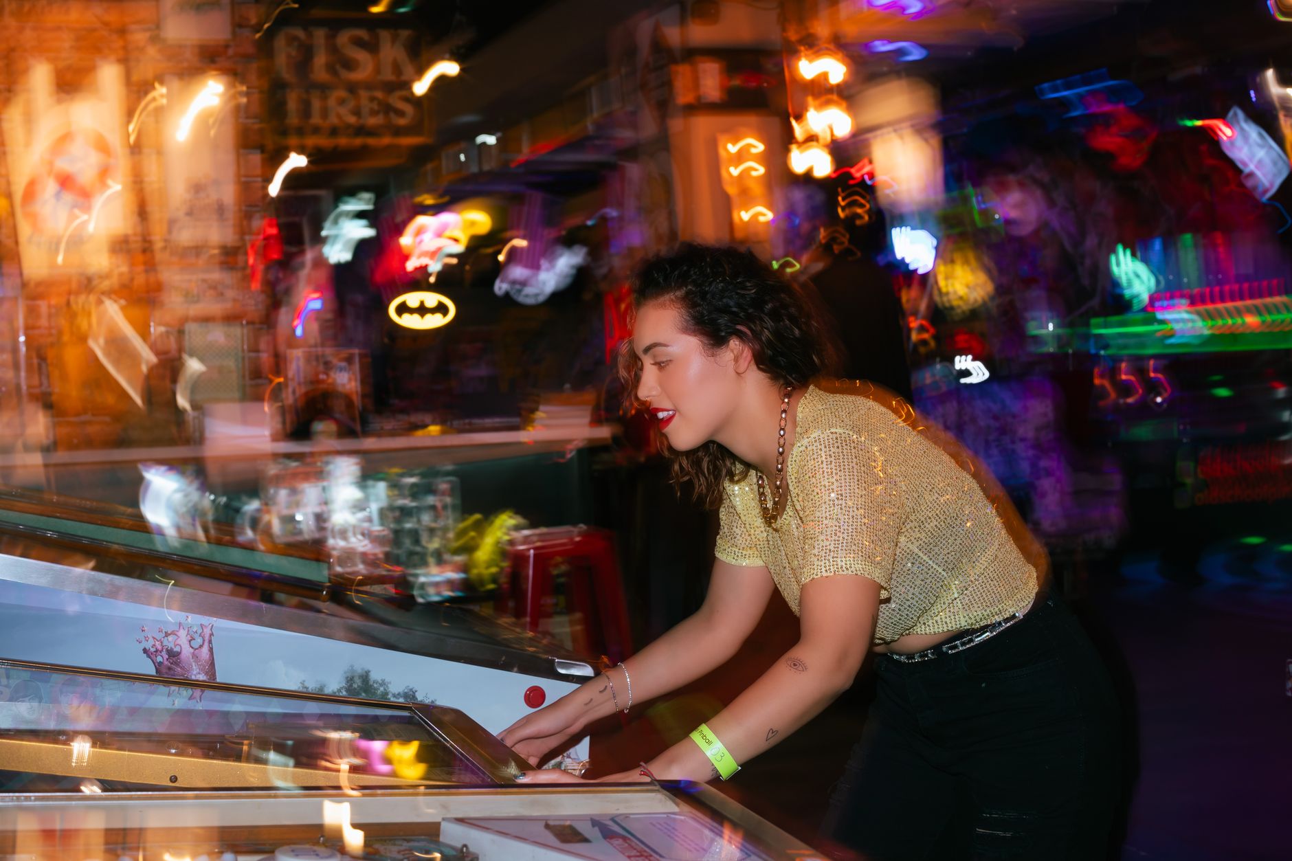 Young woman enjoying a night out playing pinball in an energetic arcade setting. — Why Mpo007 Is Trusted for Providing Transp